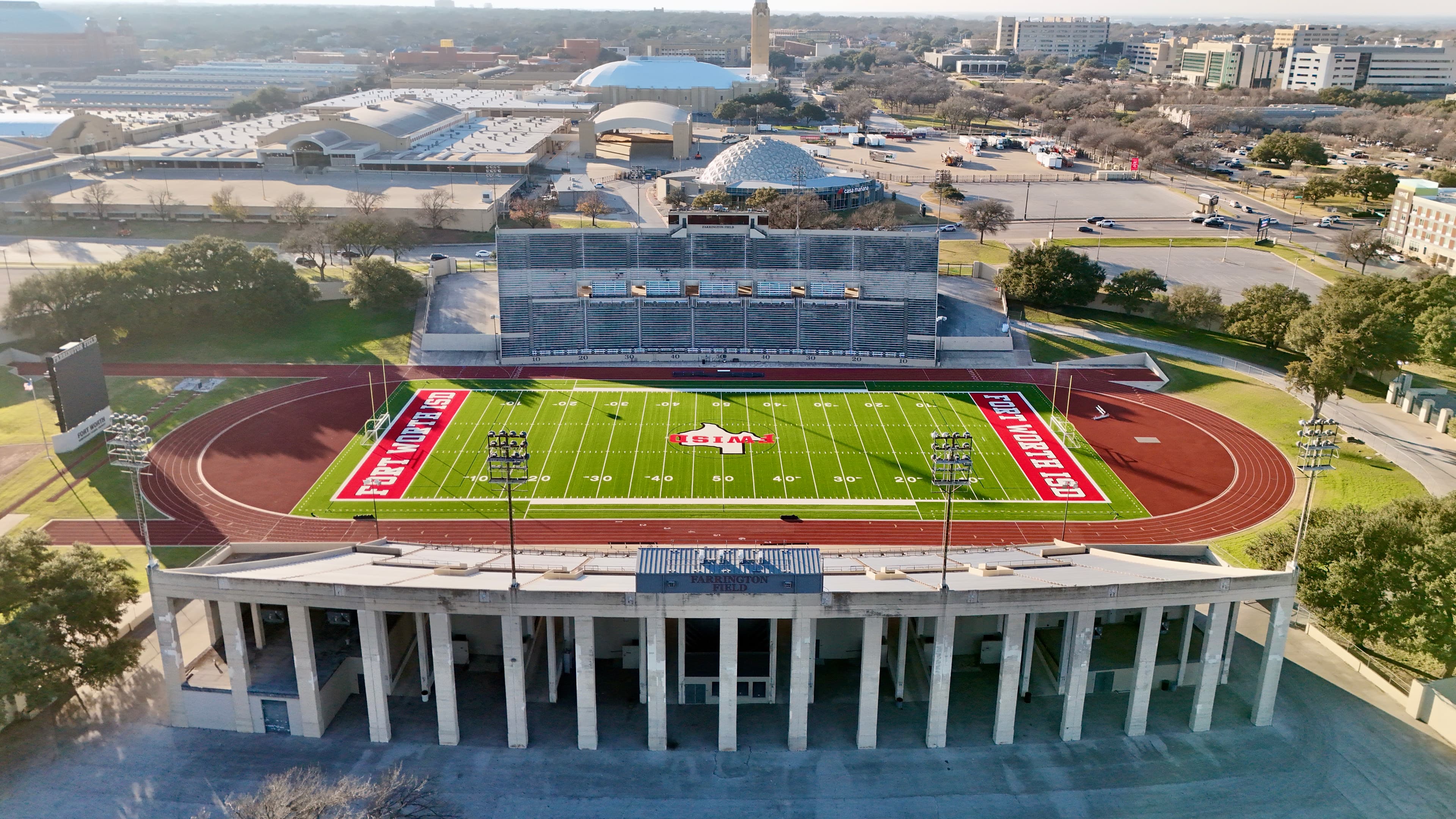 Overhead aerial view of Farrington Field stadium showing full football field with track and FWISD branding