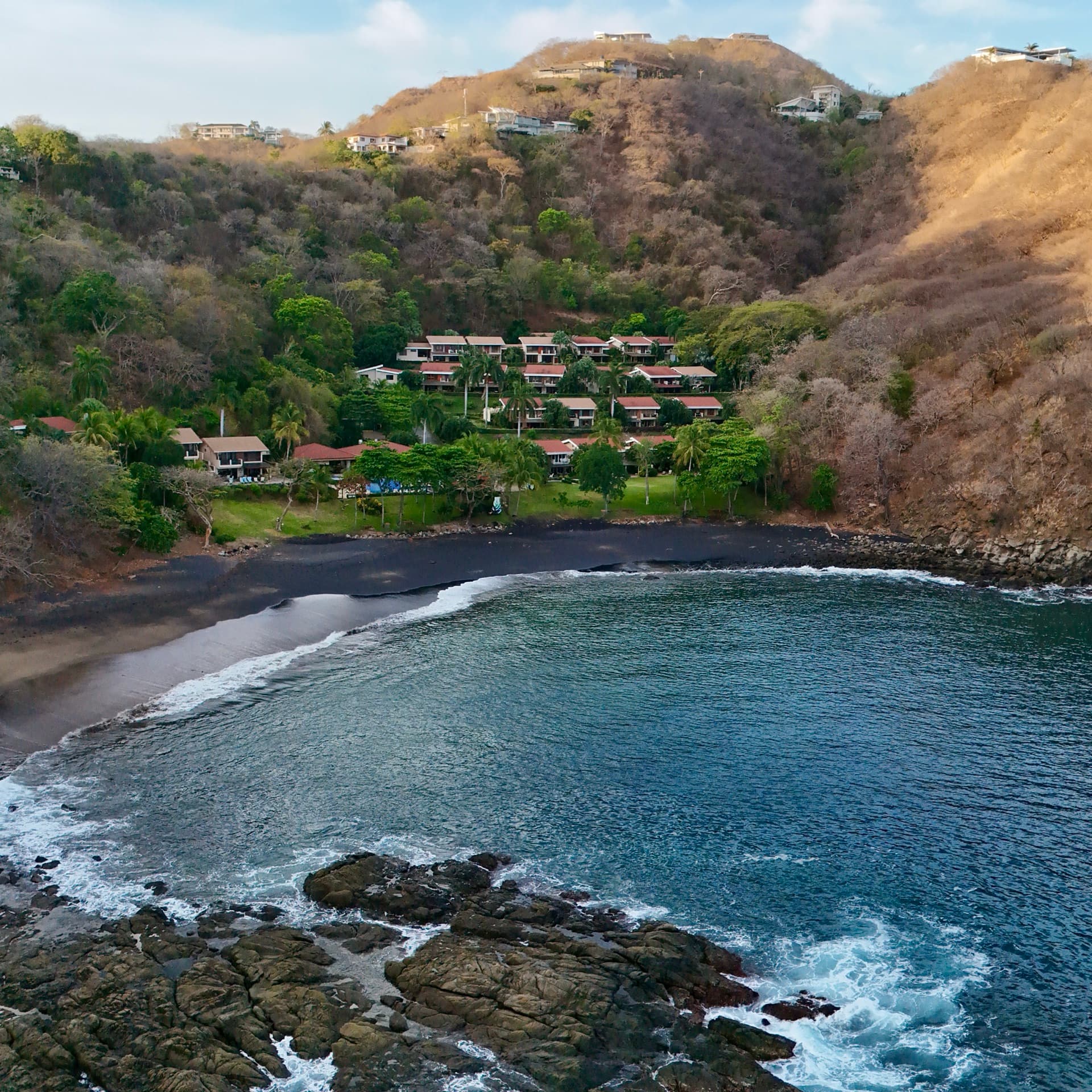 Aerial drone photo at golden hour of waterfront resort with lake views
