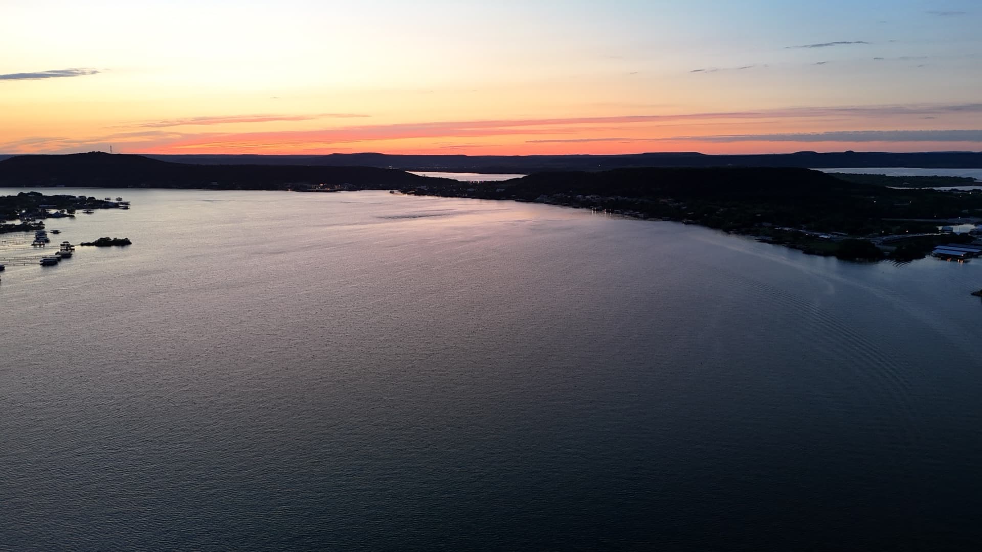 Aerial drone photo of Texas lake at sunset with shoreline and water reflections